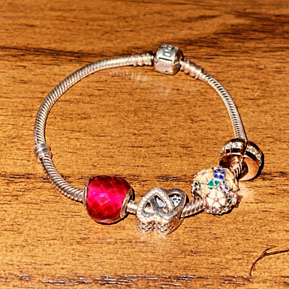 Authentic Pandora bracelet, size 7” with four authentic Pandora charms💕